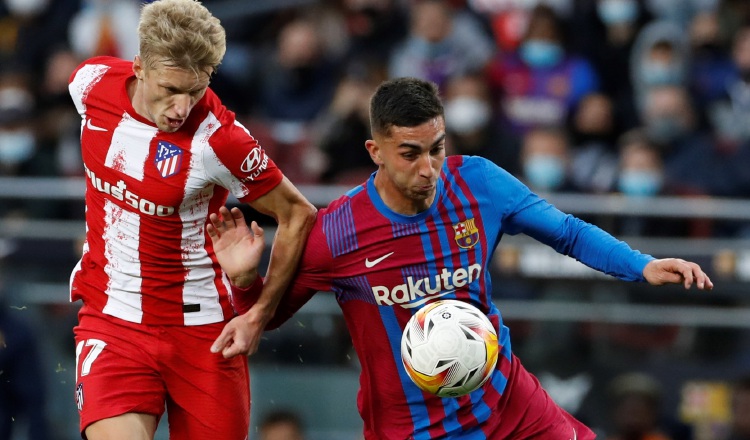 Los jugadores Daniel Wass del Atlético y Ferrán Torres (der.) del Barcelona, disputan el balón durante el partido. EFE