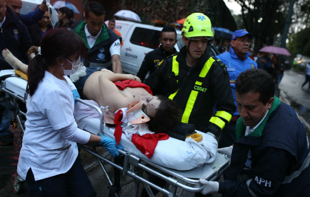 Una mujer herida por la explosión en el Centro Comercial Andino recibe primeros auxilios. FOTO/AP