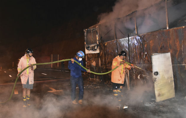 Bomberos apagan el incendio de un bus de dos pisos. FOTO/AP