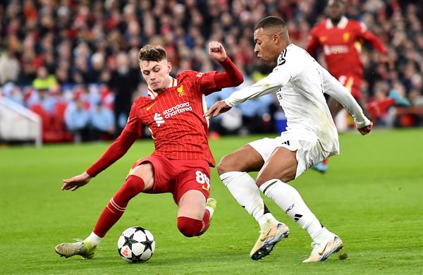 Conor Bradley del Liverpool (izq.) marca fuertemente a Kylian Mbappé del Real Madrid, en el partido de la Champions League. Foto: EFE 